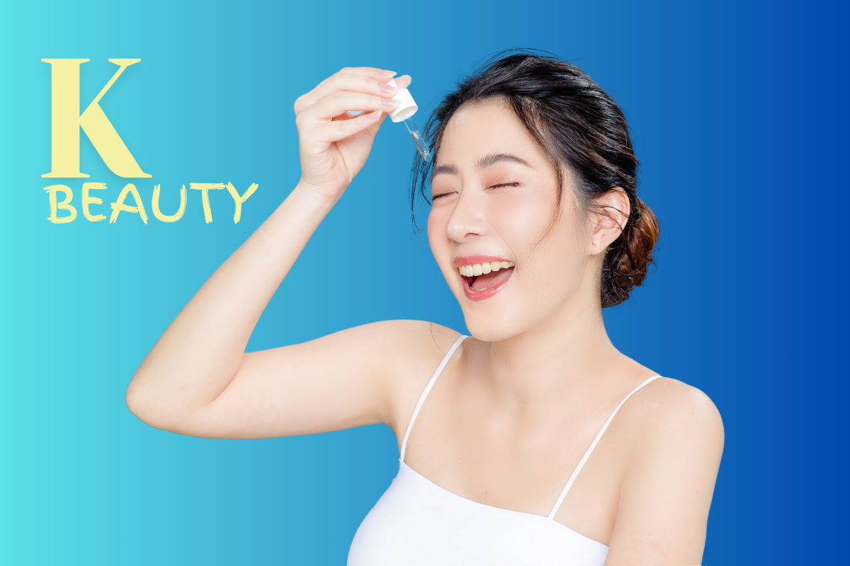 Smiling woman applying serum dropper to face with K-beauty text on blue background representing Korean skincare.