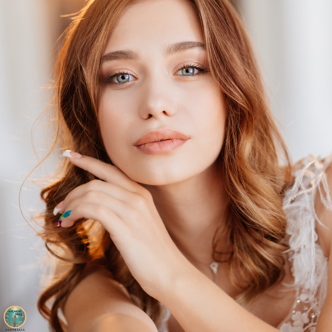 Bride with flawless glowing wedding day skin and soft makeup looking into camera