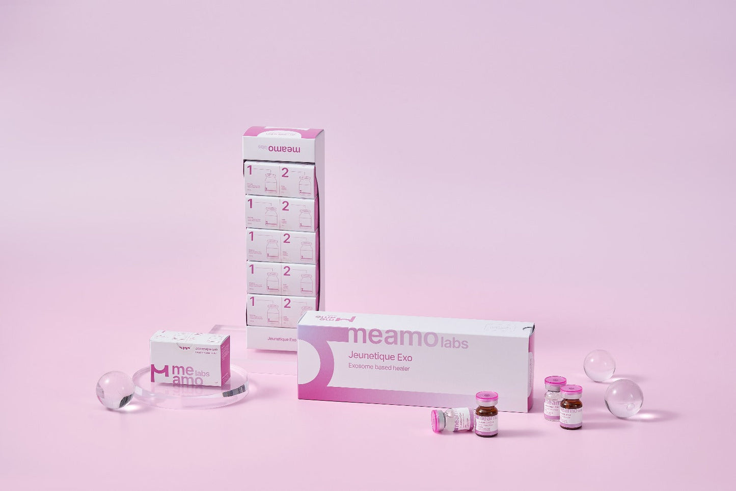 Jeunetique EXOsomes & PDRN 3% microneedling serum packaging display with product bottles and a pink background.