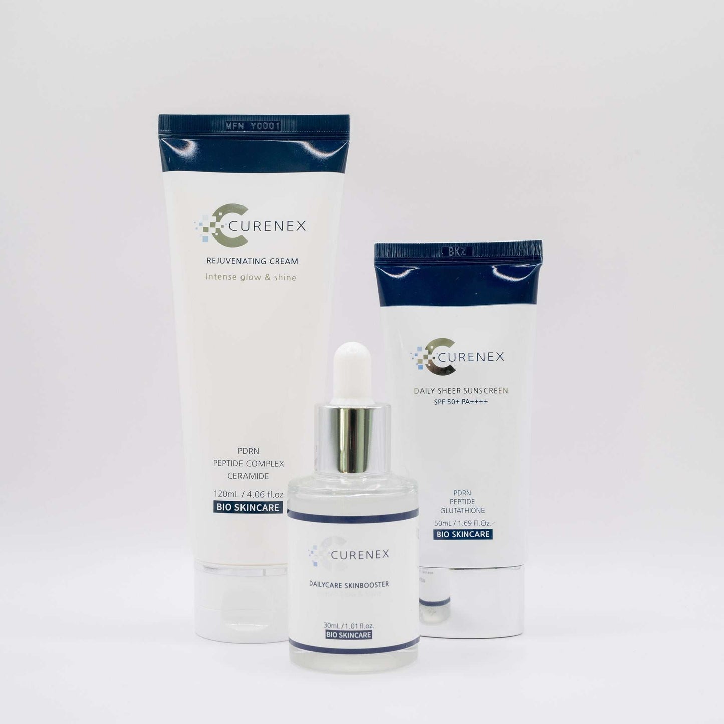 Three Curenex skincare products including Salmon DNA Sheer Sunscreen SPF50+, rejuvenating cream, and daily care skin booster on a white background