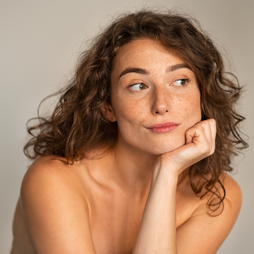 Portrait of a natural beauty woman with curly hair and clear skin, showcasing natural beauty treatments concept