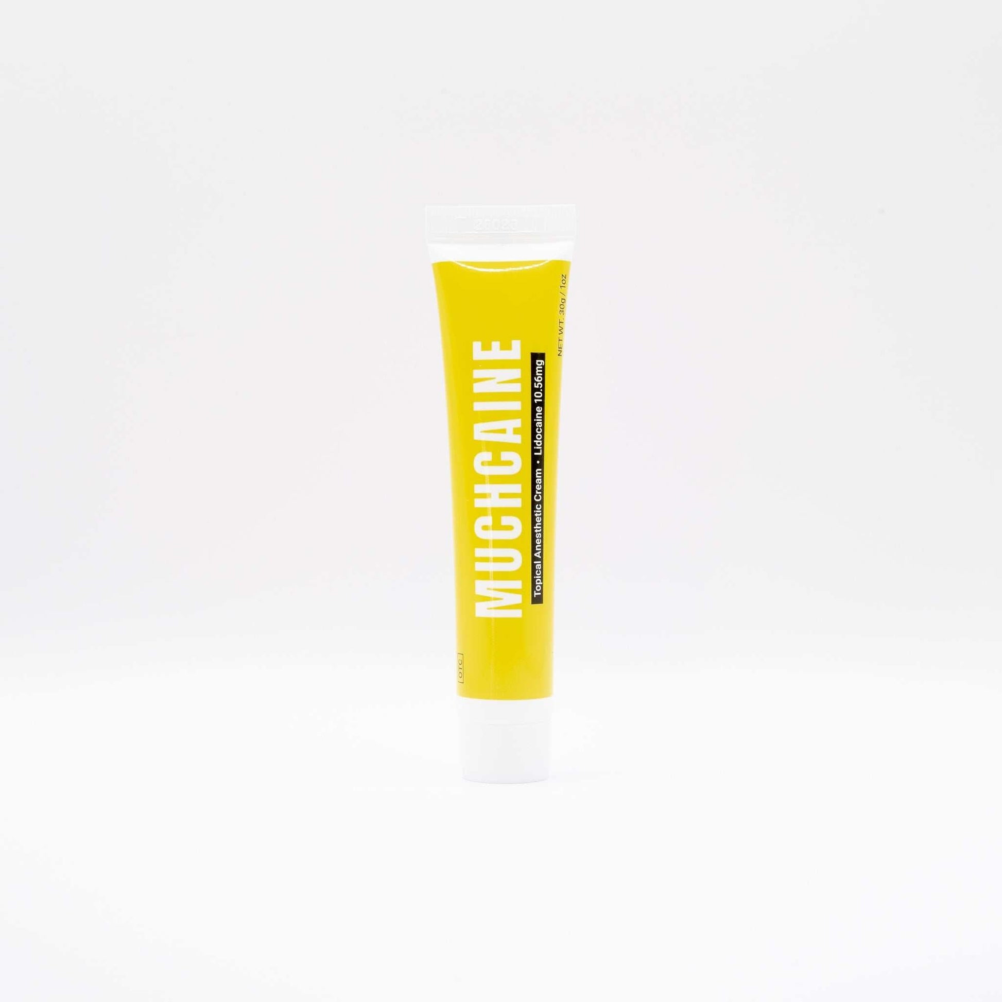 Tube of Muchcaine numbing cream for microneedling pain relief with bright yellow packaging