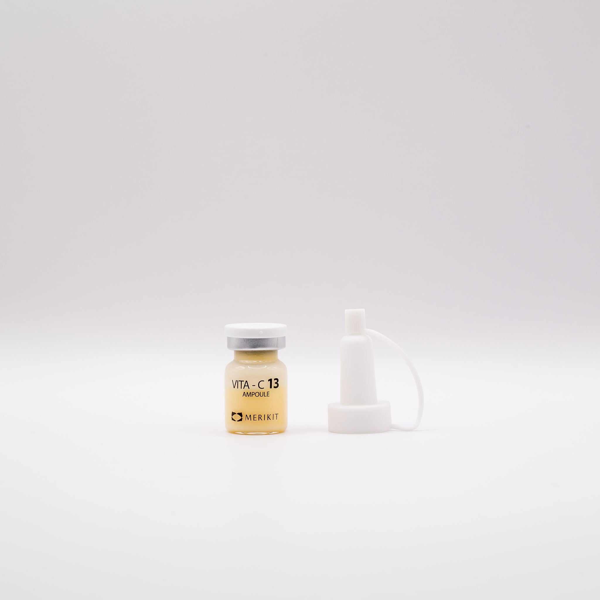 MERIKIT Vita-C 13 Ampoules bottle with white cap and dropper for brightening and anti-aging skincare