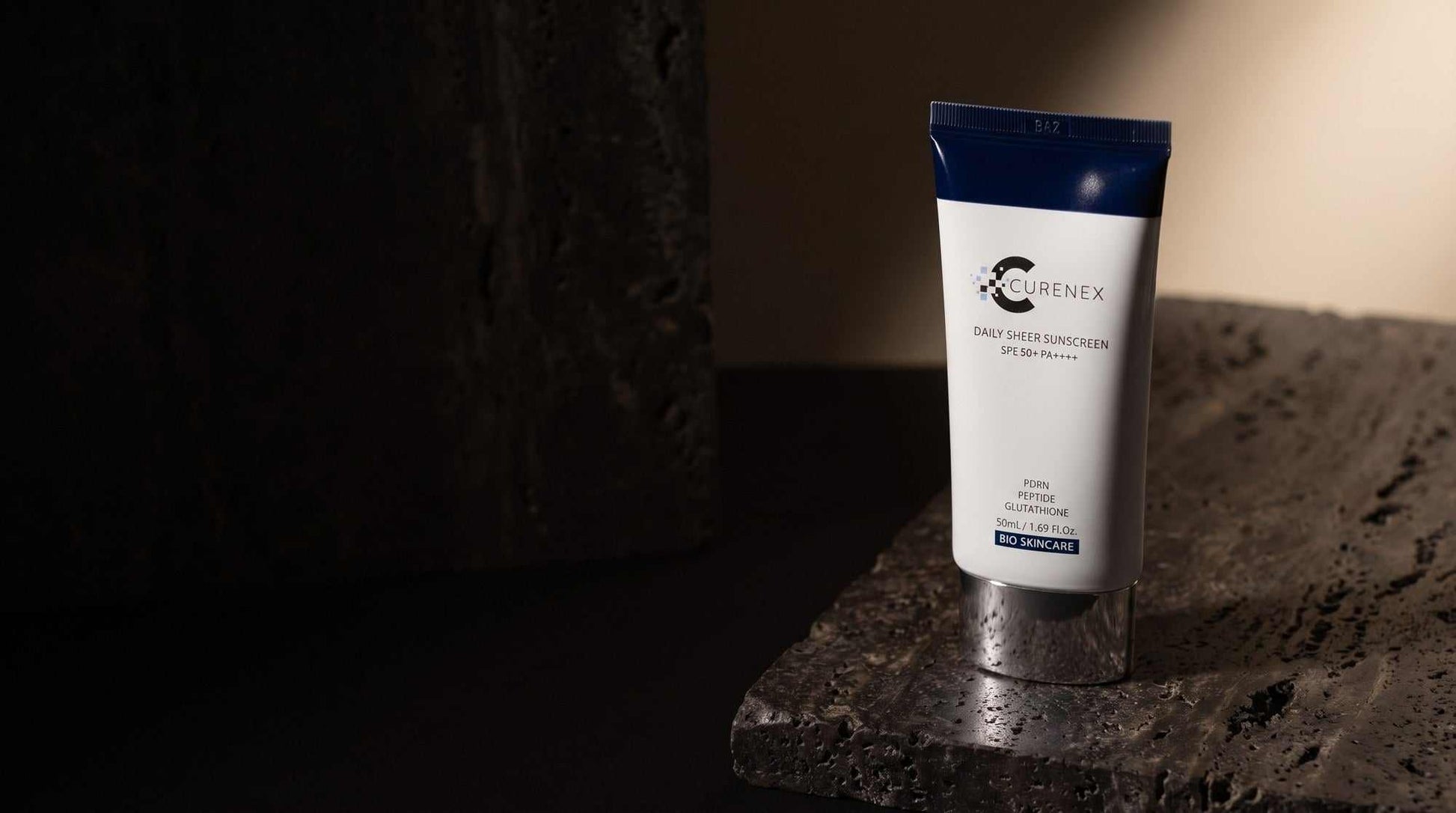 Curenex Sheer Sunscreen desktop hero of the SPF50 salmon DNA sunscreen tube