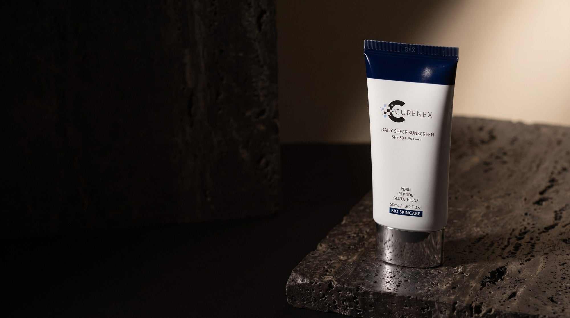 Curenex Sheer Sunscreen desktop hero of the SPF50 salmon DNA sunscreen tube