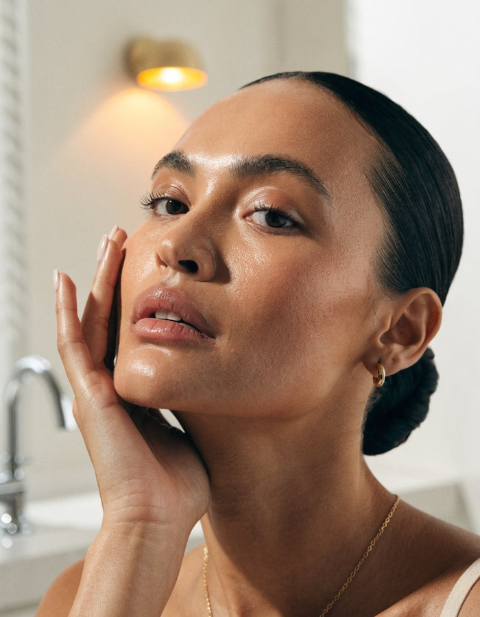 A woman with luminous skin in soft light